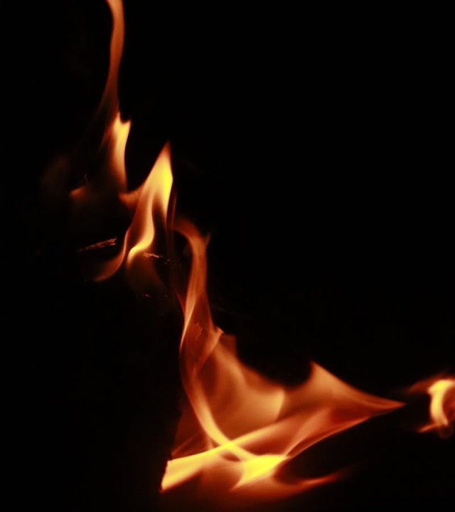 Dramatic close-up of flames against a dark background, highlighting fiery elegance.